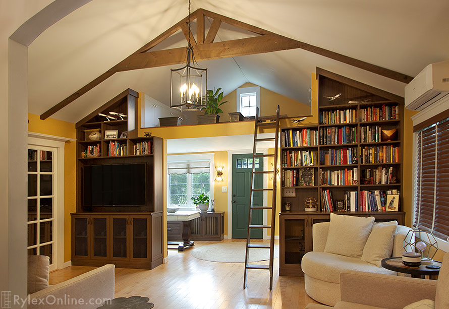 Floor to Ceiling Bookcases Frame a Loft