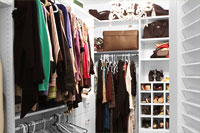 Walk-In Closet with Garment Rods, Shoe Cubbies and Dual Hamper Drawer
