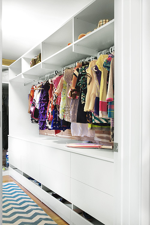 Spacious Girl's Closet with Sliding Shoe Drawer and Cabinet Drawers and Hanging Space