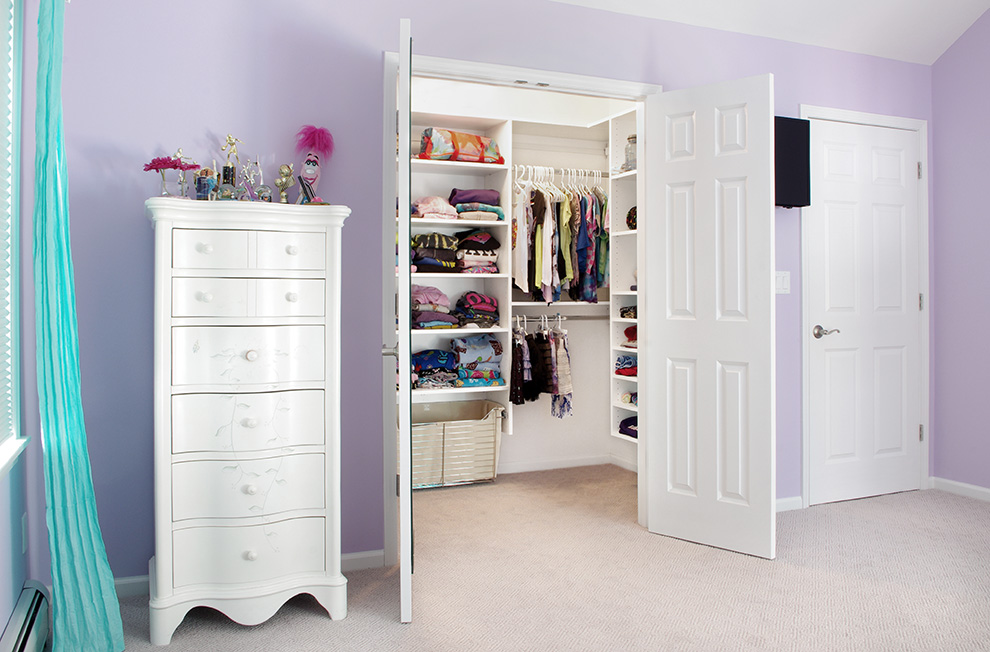 Girl's White Walk-in Closet with Adjustable Shelves and Sliding Hamper