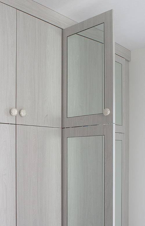 Porcelain Cabinet Knobs and Mirrored Doors Close Up