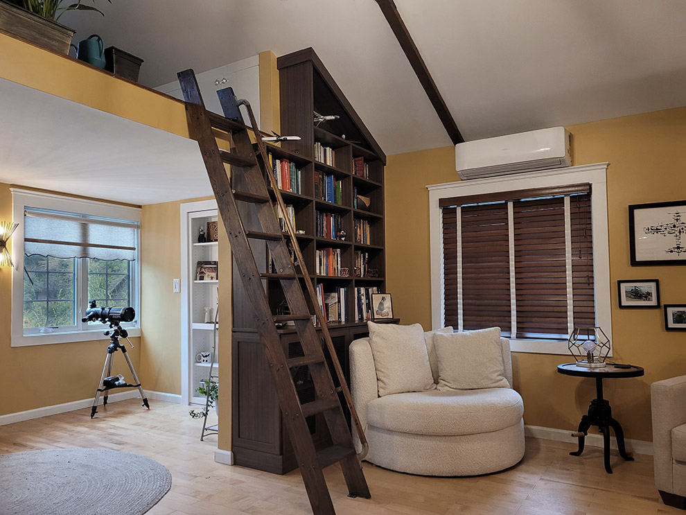 Angled Ceiling Bookcase Cabinet with Mesh Doors Covering a Radiator