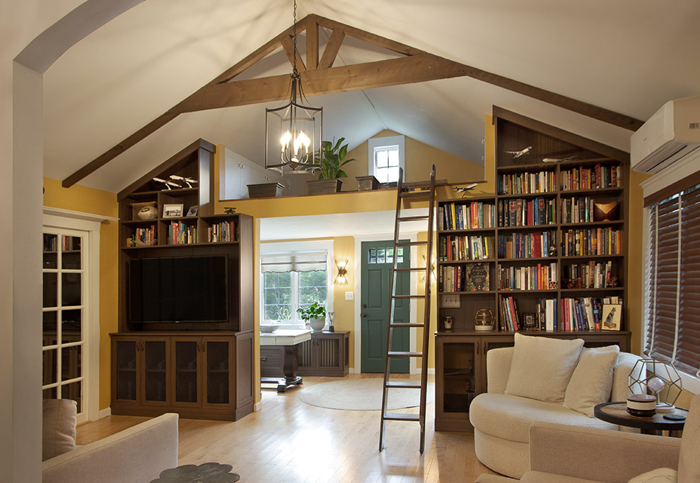 Floor to Ceiling Bookcases Frame a Loft