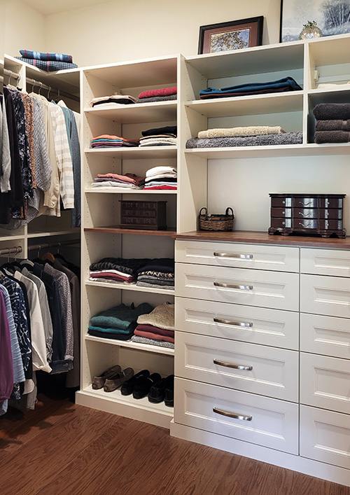 Custom Walk-In Small Closet with Built-In Bureau with Accent Wood Top and Shelves, Open Adjustable Shelves and Generous Hanging Space