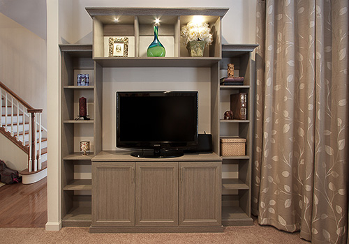 Warm Toned Family Room Entertainment Center with Open Display Shelves