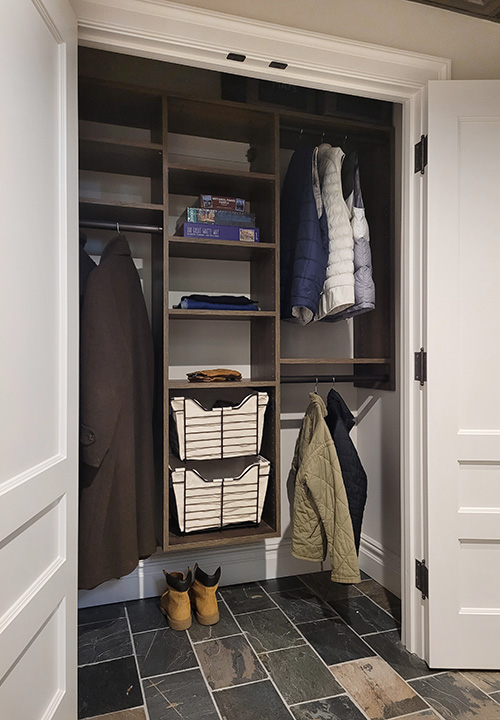 Custom Brown Halifax Oak Entry Closet with Adjustable Shelves and Sliding Baskets with Canvas Liners
