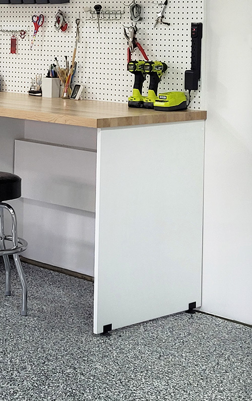 Custom Garage Cabinets with Adjustable Feet and Walnut Butcher Block Work Bench with Pegboard Organization