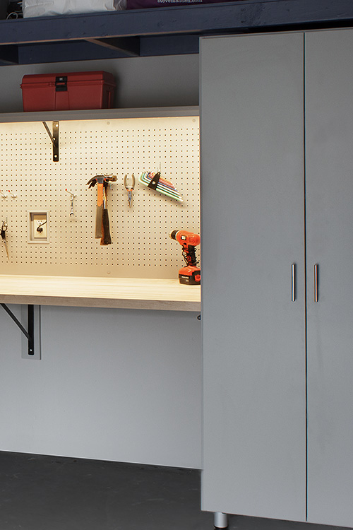 Garage Cabinet with LED Lighting on Tool Pegboard, Wood Countertop Close Up