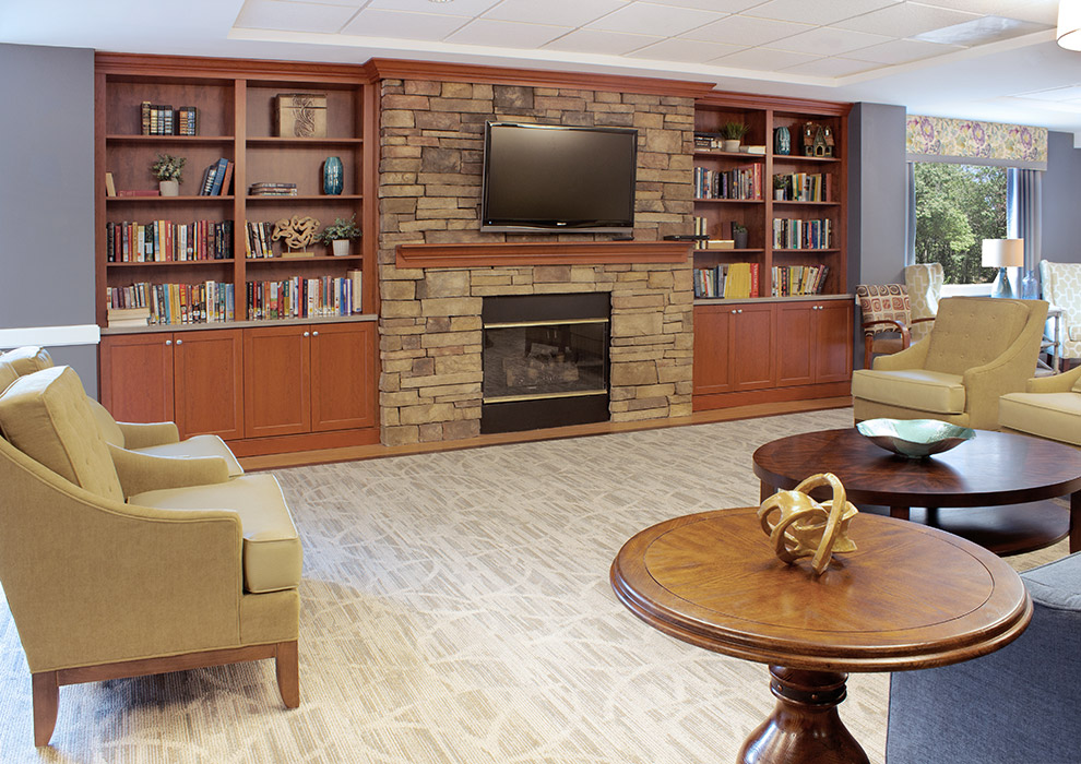 Dementia Care Community Room Cabinets Surround Fireplace