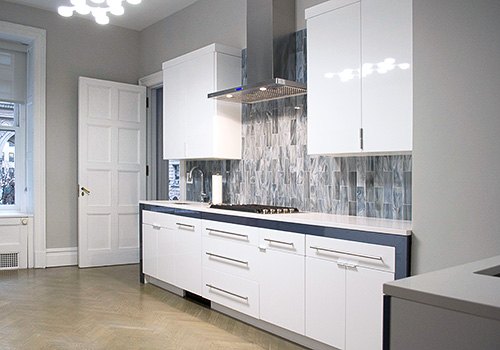 White Glossy Cabinets with Polished Metal Pull Bars