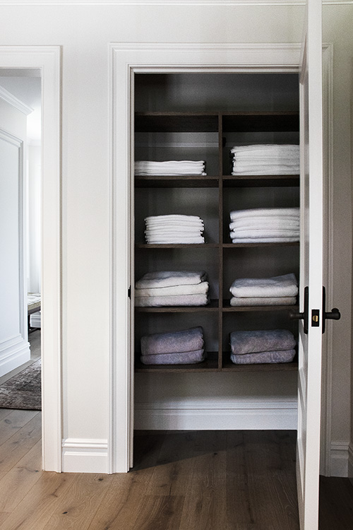 Custom Towel and Linen Storage Closet with Brown Halifax Oak Adjustable Shelving