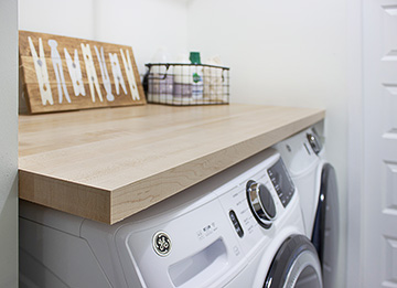 Compact Laundry Room with Butcher Block Counter