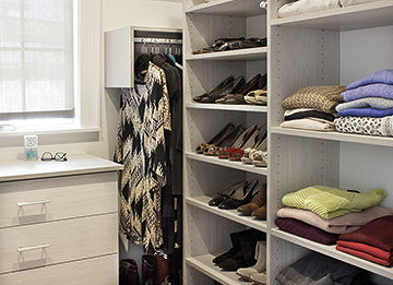 Compact Dual Master Closets with Built-In Bureaus