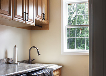 Efficient Laundry Room with Under Counter Trash Can