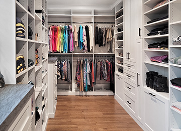 Primary White Closet with Drawers and Shoe Shelves