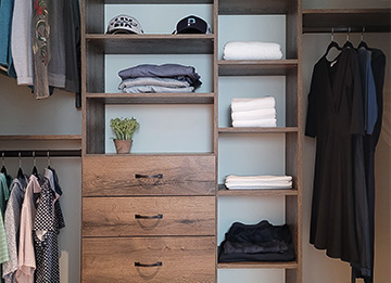 Custom Reach-in Closet in Brown Halifax Oak with Spacious Drawers and Open Shelving
